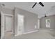 Large bedroom boasts neutral walls, carpet, fan and entry to ensuite bathroom at 1805 Hunters Moon Dr, Alpharetta, GA 30005