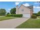 Charming home featuring a well-manicured lawn, a two-car garage, mature trees, and a brick chimney at 1805 Hunters Moon Dr, Alpharetta, GA 30005