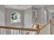 Light filled hallway with wood and white banister and arched window at 1805 Hunters Moon Dr, Alpharetta, GA 30005