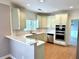Modern kitchen with stainless appliances and light colored cabinets at 1805 Hunters Moon Dr, Alpharetta, GA 30005