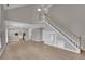 Bright living room next to kitchen with staircase and a ceiling fan at 1805 Hunters Moon Dr, Alpharetta, GA 30005