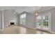 Bright living room with a fireplace, ceiling fan, and a patio at 1805 Hunters Moon Dr, Alpharetta, GA 30005