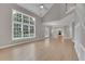 Bright living room next to kitchen with staircase and large windows at 1805 Hunters Moon Dr, Alpharetta, GA 30005