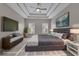 This bedroom features a tray ceiling, recessed lighting, a ceiling fan, and a large wall-mounted television at 1805 Hunters Moon Dr, Alpharetta, GA 30005