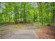 Backyard featuring a wooden deck area, partially fenced with wooded landscape in the background at 3021 Mills Ridge Dr, Canton, GA 30114
