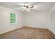 Bedroom featuring wood-look floors, a ceiling fan, closet, and window overlooking the backyard at 3021 Mills Ridge Dr, Canton, GA 30114
