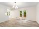 Dining area with bright double doors leading to the deck and contemporary chandelier at 3021 Mills Ridge Dr, Canton, GA 30114