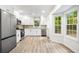 Modern kitchen features stainless steel appliances, white cabinets, and large windows at 3021 Mills Ridge Dr, Canton, GA 30114