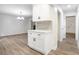 Bright living room and hallway view with hardwood floors and white cabinets at 3021 Mills Ridge Dr, Canton, GA 30114