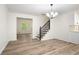 Bright living room with hardwood floors, modern chandelier, staircase, and view to kitchen at 3021 Mills Ridge Dr, Canton, GA 30114