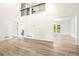 Spacious living room with soaring ceiling, flowing to the dining area, featuring attractive wood floors at 3021 Mills Ridge Dr, Canton, GA 30114