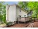Home featuring a wooden deck and a path leading through landscaped greenery at 3021 Mills Ridge Dr, Canton, GA 30114