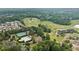 An expansive aerial view highlighting the golf course, community pool, and residential area surrounded by lush greenery at 322 Woodridge Pass, Canton, GA 30114