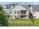 Spacious backyard with a fenced perimeter, covered patio, and stairs leading to an upper level deck at 322 Woodridge Pass, Canton, GA 30114