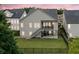 Backyard view with a fenced lawn, covered patio, upper deck, and stairs at 322 Woodridge Pass, Canton, GA 30114