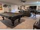Spacious basement featuring a covered pool table, comfortable seating, and ample room for recreation and entertaining at 322 Woodridge Pass, Canton, GA 30114