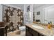 Well-maintained bathroom features granite countertop and decorative shower curtain with plenty of towel storage at 322 Woodridge Pass, Canton, GA 30114