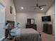 Relaxing bedroom with a ceiling fan, soft carpeting, neutral walls, and a full set of wooden furniture at 322 Woodridge Pass, Canton, GA 30114