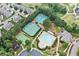 Aerial view showcasing community amenities, including a pool, tennis courts, playground, and clubhouse at 322 Woodridge Pass, Canton, GA 30114