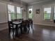 Inviting dining room with hardwood floors, large windows, and a stylish chandelier over a table with seating for eight at 322 Woodridge Pass, Canton, GA 30114