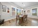 Dining room featuring natural light, wood floors and modern decor, offering a welcoming space for gatherings at 322 Woodridge Pass, Canton, GA 30114