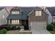 Charming two-story home with cedar shake siding, dormer windows, and a well-manicured front yard at 322 Woodridge Pass, Canton, GA 30114