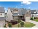 Lovely two-story home with a well-maintained lawn, established landscaping, and an inviting front porch at 322 Woodridge Pass, Canton, GA 30114