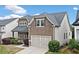 Two-story home with a neutral color scheme, well-kept landscaping, and an attached two-car garage at 322 Woodridge Pass, Canton, GA 30114