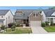 Beautiful two-story home with a well-maintained lawn, lush landscaping, and a welcoming front porch at 322 Woodridge Pass, Canton, GA 30114