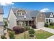 Charming two-story home with a welcoming front porch, well-manicured lawn, and mature landscaping at 322 Woodridge Pass, Canton, GA 30114