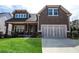 Charming two-story home featuring a well-manicured lawn, shingle siding, and an attached two-car garage at 322 Woodridge Pass, Canton, GA 30114