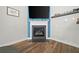 Fireplace in open-concept living area with modern design, hardwood floors, and bright, natural light at 322 Woodridge Pass, Canton, GA 30114