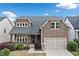 Charming two-story home with shake siding, covered porch, a two-car garage and well-manicured landscaping at 322 Woodridge Pass, Canton, GA 30114