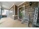 Inviting front porch featuring stone accents, a rocking chair, and a warm 'Welcome' sign at 322 Woodridge Pass, Canton, GA 30114