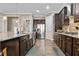Modern kitchen with dark cabinetry, granite countertops, stainless steel appliances, and ample storage at 322 Woodridge Pass, Canton, GA 30114