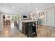 Open-concept kitchen with a large center island, stainless steel appliances, and adjacent dining area at 322 Woodridge Pass, Canton, GA 30114