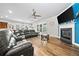 Open-concept living area with wood floors, fireplace, modern furnishings and ample natural light at 322 Woodridge Pass, Canton, GA 30114