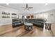 Spacious living area with wood floors, ample seating, modern lighting, and seamless transition to kitchen at 322 Woodridge Pass, Canton, GA 30114