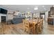 Open-concept space featuring wood floors, fireplace, modern furnishings and seamless transition to the dining area at 322 Woodridge Pass, Canton, GA 30114