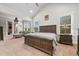 Vaulted ceiling main bedroom with sitting area, natural light, and large bed at 322 Woodridge Pass, Canton, GA 30114