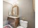 Chic bathroom highlighting a wooden vanity, framed mirror, and neutral tones at 1290 Nervi Nw Mews, Atlanta, GA 30318
