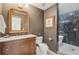 Elegant bathroom boasting a wooden vanity, stylish mirror, and tiled shower at 1290 Nervi Nw Mews, Atlanta, GA 30318