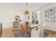 Bright dining room featuring a wooden table, neutral decor, hardwood floors, and natural light at 1290 Nervi Nw Mews, Atlanta, GA 30318