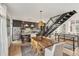 Open-concept dining room with views to the kitchen, hardwood floors, and modern staircase at 1290 Nervi Nw Mews, Atlanta, GA 30318
