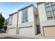Contemporary townhome featuring a modern facade, individual garages, and large windows for natural light at 1290 Nervi Nw Mews, Atlanta, GA 30318