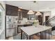 Modern kitchen with stainless steel appliances, marble countertops, dark wood cabinets, and island at 1290 Nervi Nw Mews, Atlanta, GA 30318