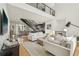 Bright living area with modern staircase, open floor plan, hardwood floors, and views into the adjacent kitchen at 1290 Nervi Nw Mews, Atlanta, GA 30318