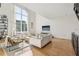 Open living space features soaring ceilings, large windows, wood floors, and lots of natural light at 1290 Nervi Nw Mews, Atlanta, GA 30318