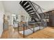 Modern living area with open staircase, hardwood floors, and views into the dining and kitchen area at 1290 Nervi Nw Mews, Atlanta, GA 30318