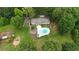 Aerial perspective of the property showcasing the pool, home, yard, outbuildings and the surrounding trees at 400 Simpson Ne Rd, White, GA 30184